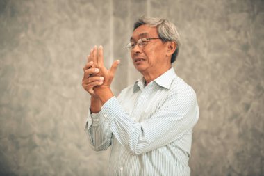 Yaşlı adam aşağı düşen sonra elinde acı.