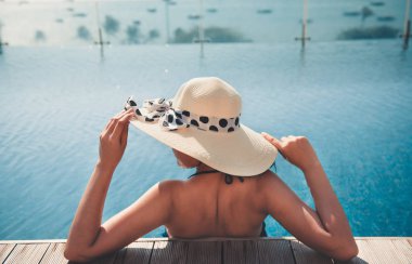 Asyalı kadın ile sunbathe yüzme havuzunda rahatlatıcı portresi.