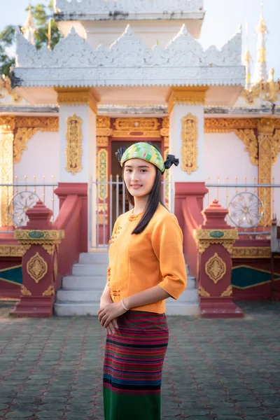 Portrait of asian ethics woman in traditional clothing in front of the temple., Attractive young woman wearing vintage old fashion of Shan State., Asian religion and antique concept.