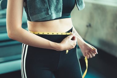 Başarılı kilo kaybı Fitness Spor salonu arka plan., sağlık, diyet kavramı içinde bant ölçme ile gösterilen güzel kadın portresi