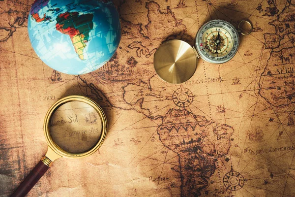 Navigation Explore of Journey Planning., Travel Destination and Expedition Plan Vacation trip., Close Up of Layout Magnifying Glass, Compass on The World Map Background.