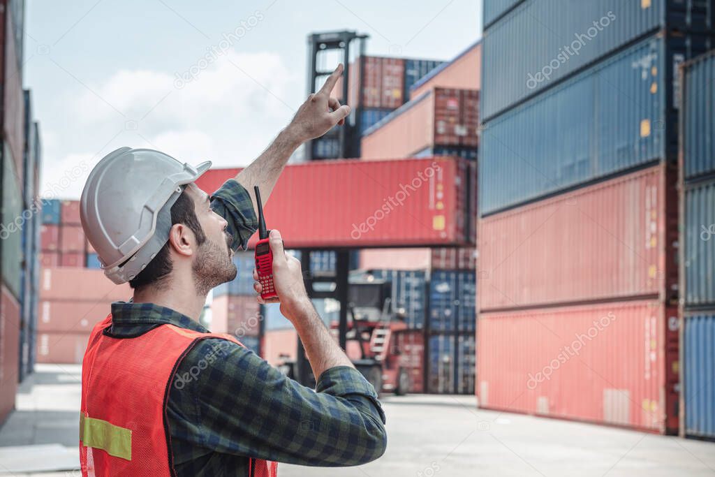 Container Logistics Shipping Management of Transportation Industry, Transport Engineer Managing Control Via Walkie Talkie in Containers Shipyard. Business Cargo Ship Import/Export Factory Logistic.