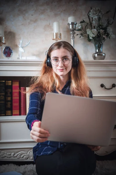 Leisure Activity and Home Relaxing Lifestyle Concept, Attractive Woman Having Enjoyment While Listening Music Songs Via Headphone on Laptop in Living Room. Relaxation Pursuit Entertainment at Home