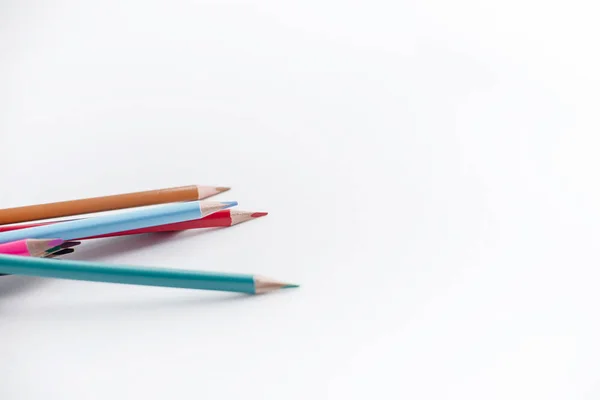 Color pencils on white background. Education, school concept. Close up.Seamless colored pensils