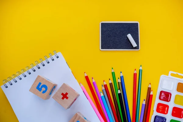 Back to school colorfull flatlay. Pencils notepad numbs a b c alphabet waterolors. Horizontal top view several objects above. — Stock Photo, Image