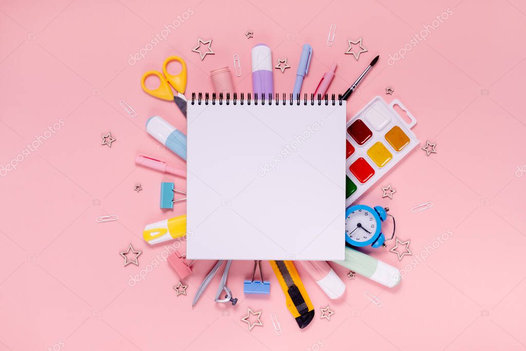 Back to school concept notepad, pencil case, stationery and school supplies. Top horizontal view copyspace pink background