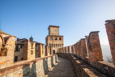 Castello di Vigoleno, in the Emilia Romagna province of Piacenza, with the walls and the town. Vigoleno 02/17/2019 at 12:30 pm clipart