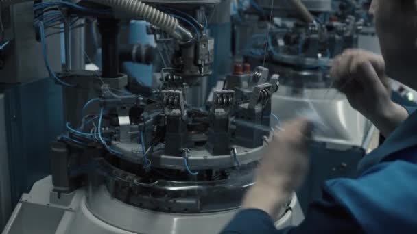 Мужчина готовит рабочее место на швейной фабрике — стоковое видео