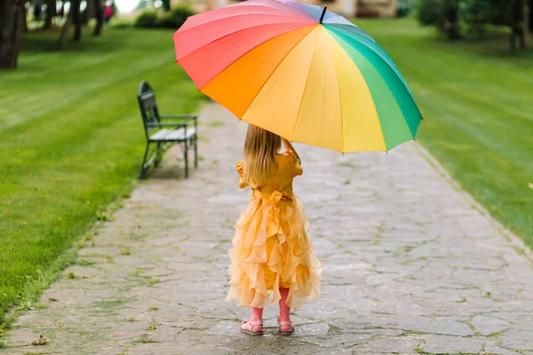 Happy girl with a multicolored umbrella. — Stock Photo, Image