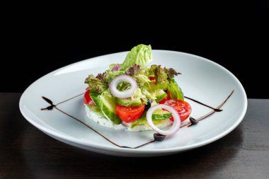 Peynir ve beyaz plaka üzerinde taze sebze salatası.