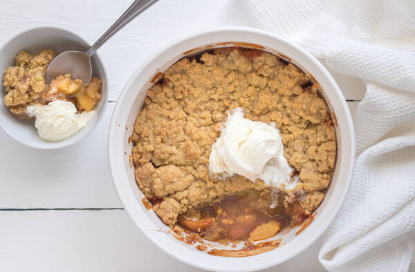 Apple crumble dessert with vanilla icecream on white background - Top view photo
