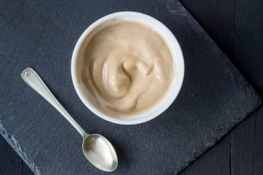 Çikolata aromalı yoğurt, siyah arka planda izole edilmiş, yazı için yeri var. Üst görünüm.