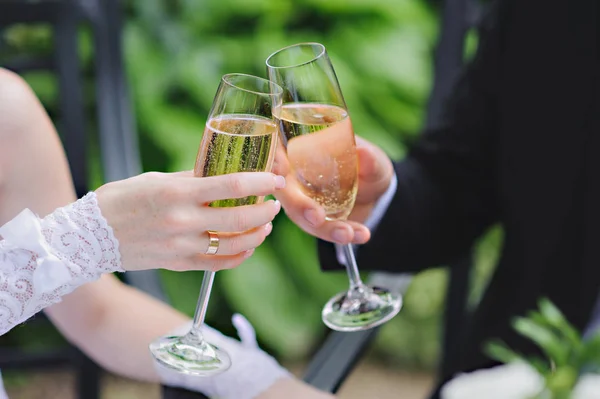 Wedding Couple Champagne Toast.Hands with glass and strawberry. Horizontal.