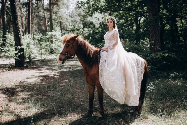 Forest walk of the bride on horseback.