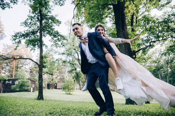 Newlyweds dance and have fun outdoors.