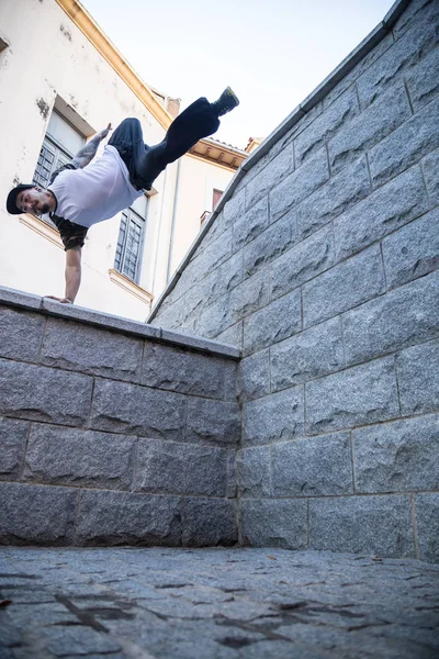 Young man doing an amazing parkour trick on the street.