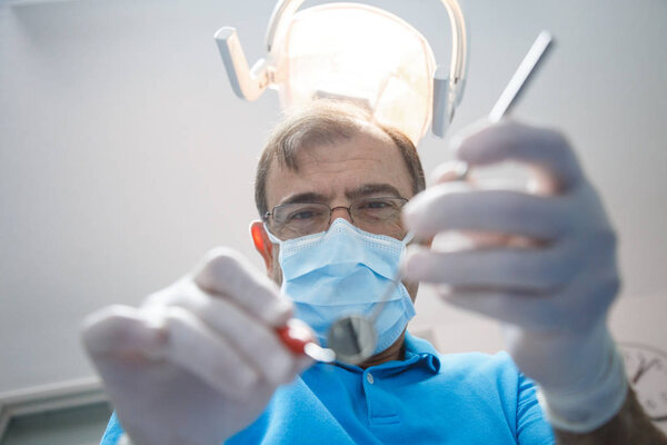 Professional dentist examining patient 