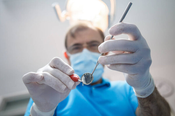 Professional dentist examining patient 