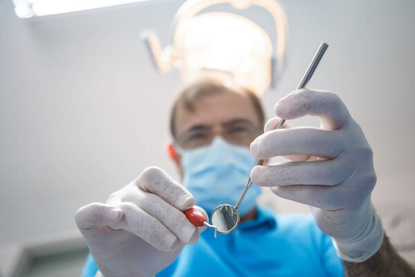 Professional dentist examining patient 