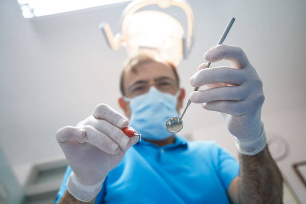 Professional dentist examining patient 