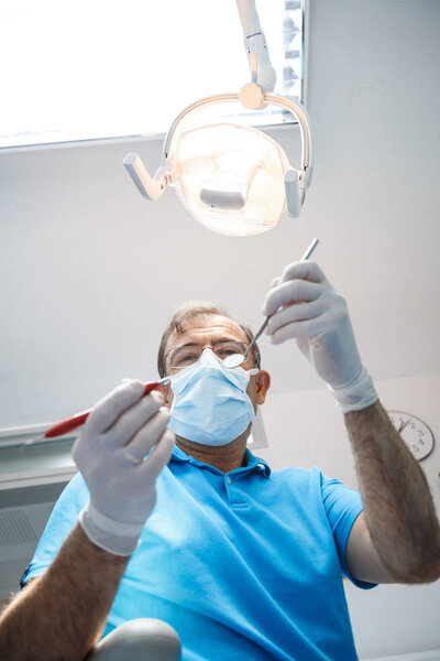 Professional dentist examining patient 