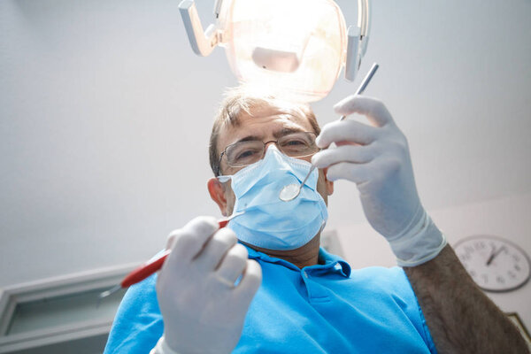 Professional dentist examining patient 