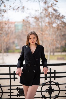 Bir çit oturan bir parkta poz güzel model kadın