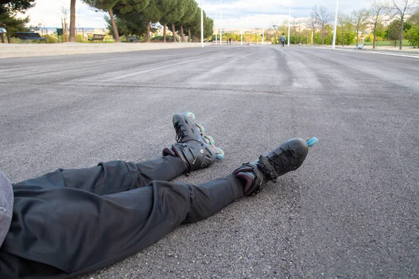Crop Young Tired Fit Man Sportswear Roller Skates Lying Road — Stock Photo, Image