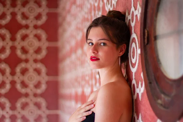 Портрет Молодой Красивой Женщины Опирающейся Розовую Стену Белым Орнаментом Смотрящей — стоковое фото