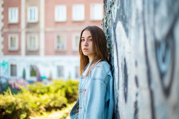 Красивая Молодая Женщина Повседневной Одежде Опирающаяся Выветрившуюся Стену Граффити Стоя — стоковое фото
