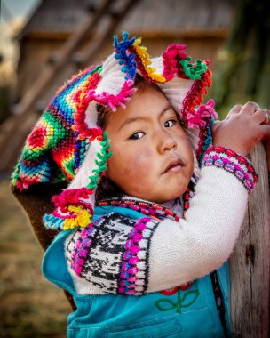 Young peruvian girl wearing traditional clothes on Uros island, 
