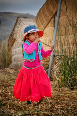 Young peruvian girl wearing traditional clothes on Uros island, 