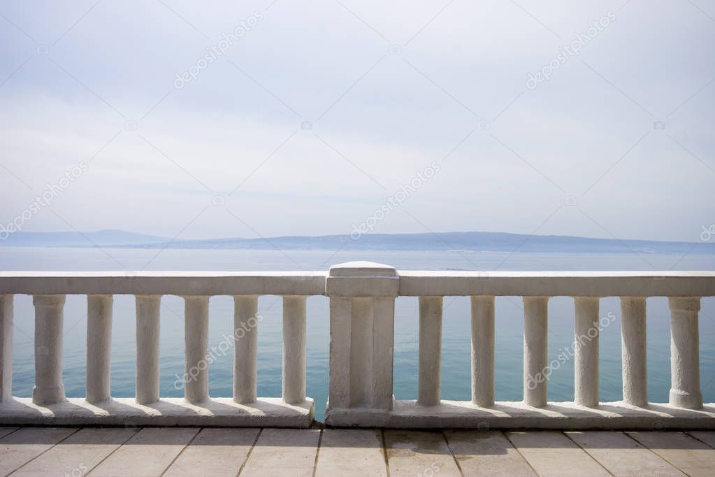 Promenade path near the mediterranean sea, concrete fence - off 