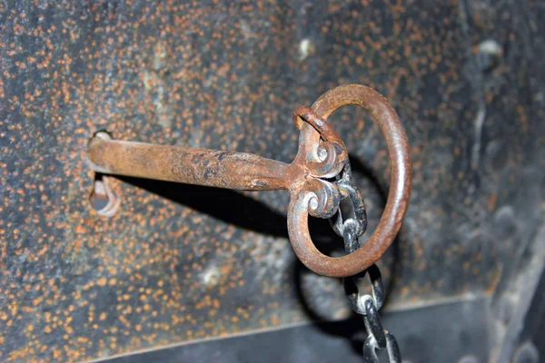 old medieval dungeon key in rusty iron door