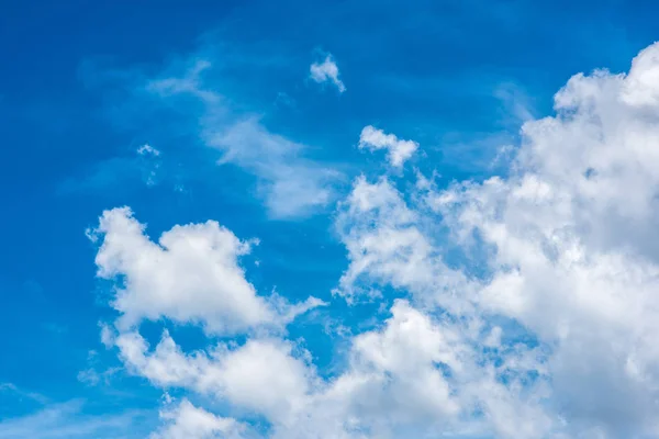 Diverse cloud formations in the blue sky above the sea in May in Suan Soan Pradipat, Hua Hin, Thailand. Summer nature blue background. Copy space for text or logo.