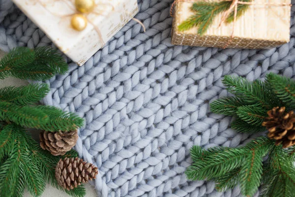 Christmas composition, gray knitted plaid, cones, fir branches — Stock Photo, Image