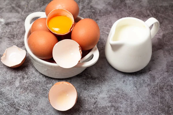 stock image eggs and milk on gray background close-up