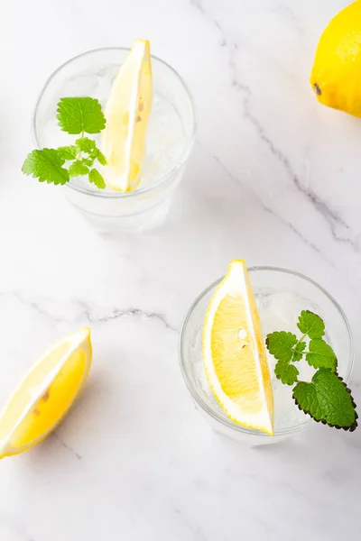 refreshing drink with ice lemon in glasses top view