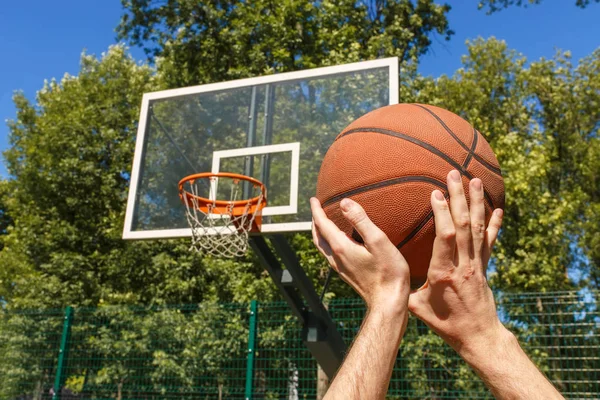 Manos lanzando pelota de baloncesto — Foto de Stock