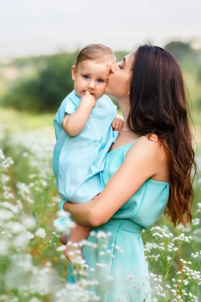 Mother holding little daughter on summer meadow — Stock Photo, Image