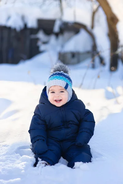 Baby boy sitting on snow — Stock Photo, Image
