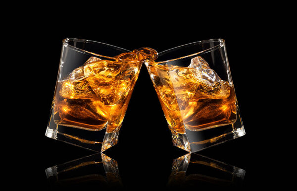 glasses of whiskey making toast