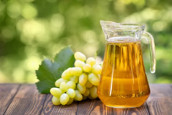 Grape juice in glass jug — Stock Photo, Image