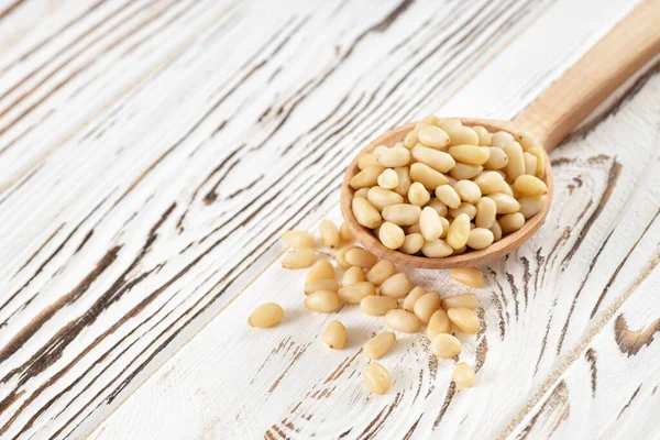 Cedar nuts in spoon — Stock Photo, Image