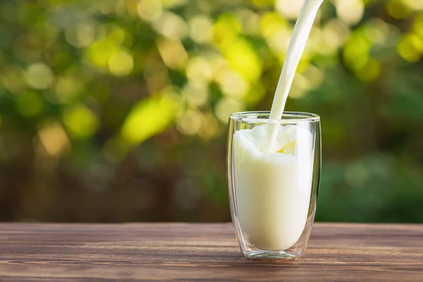 Mjölk som hälls i glas — Stockfoto