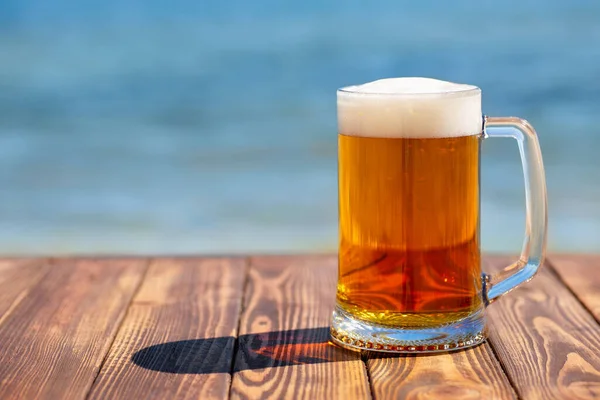 Mug of beer with froth and bubbles Royalty Free Stock Images