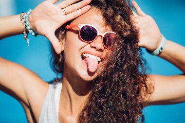 Close up portrait Nice laughing girl making selfie on the beach.Cute summer fashion portrait of beauty long curly dark hair woman having fun.