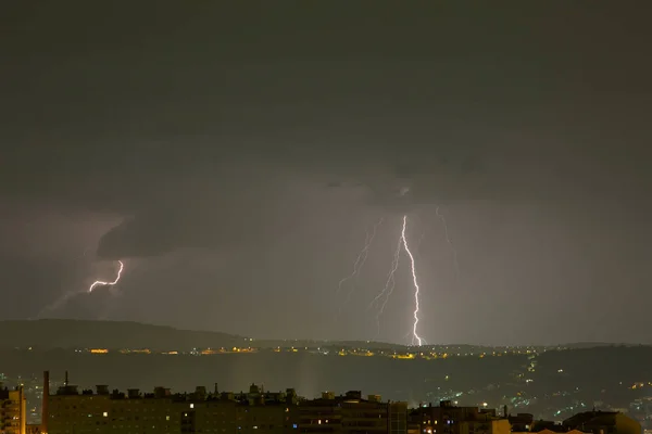 Thunderstorm near the city of Trieste, Italy , lightning beats the water