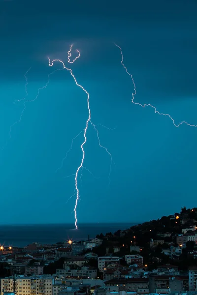 Thunderstorm near the city of Trieste, Italy , lightning beats the water