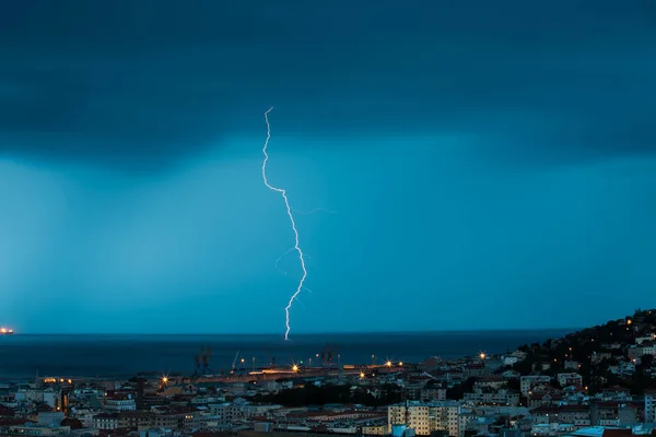 Thunderstorm near the city of Trieste, Italy , lightning beats the water